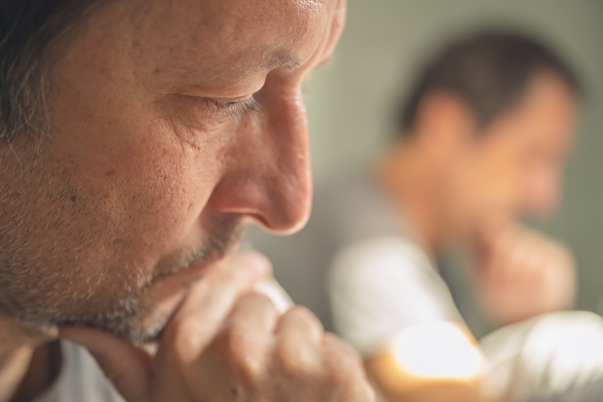 Rethinking concept, closeup portrait of unshaved mature adult unhappy and distraught, alone at home, with mirror reflection